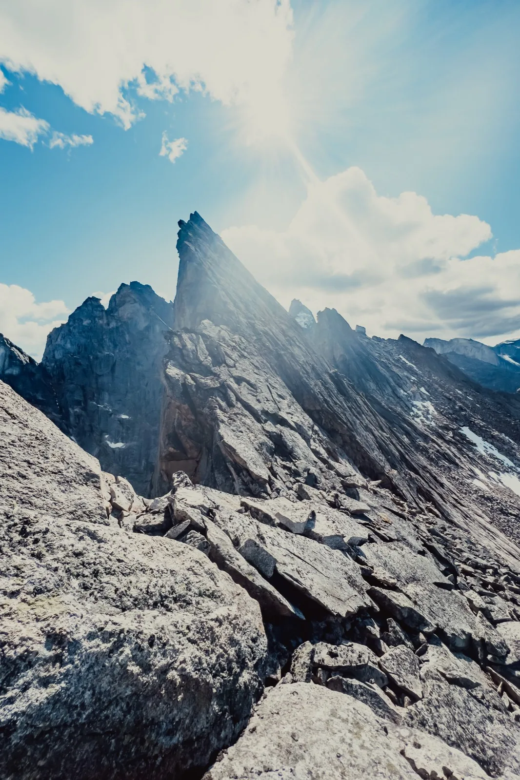 Low sun cutting across a range of sharp peaks