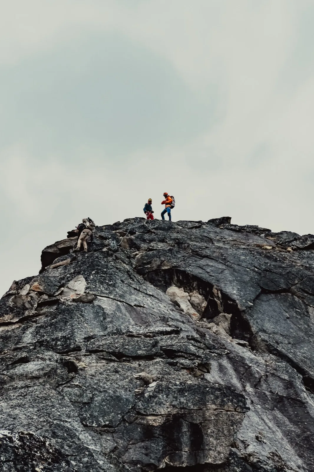 Hikers silhouetted along a mountain ridge