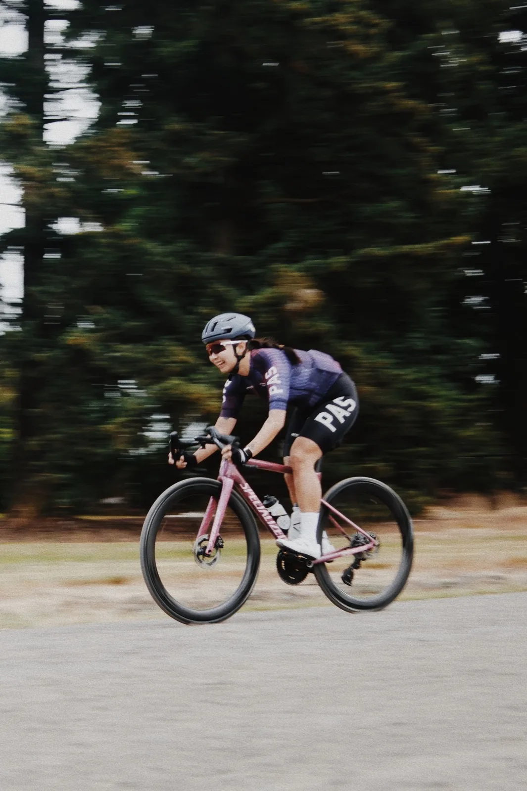 A cyclist streaking past in colorful motion blur