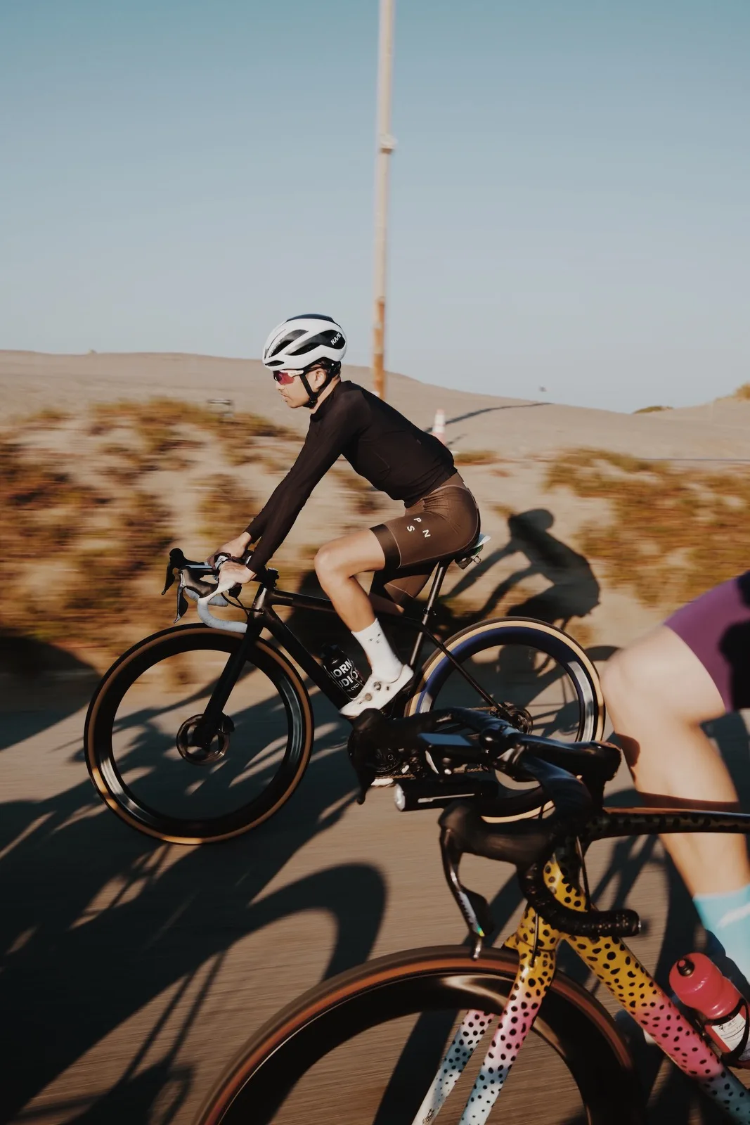 A cyclist rendered in a sharp horizontal pan