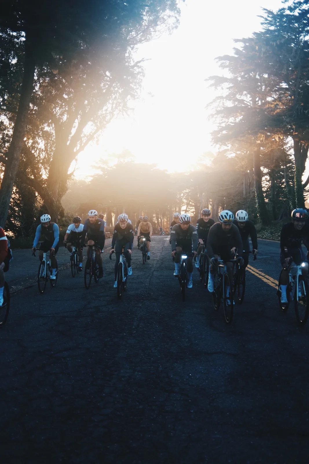 A cycling group silhouetted by strong backlight