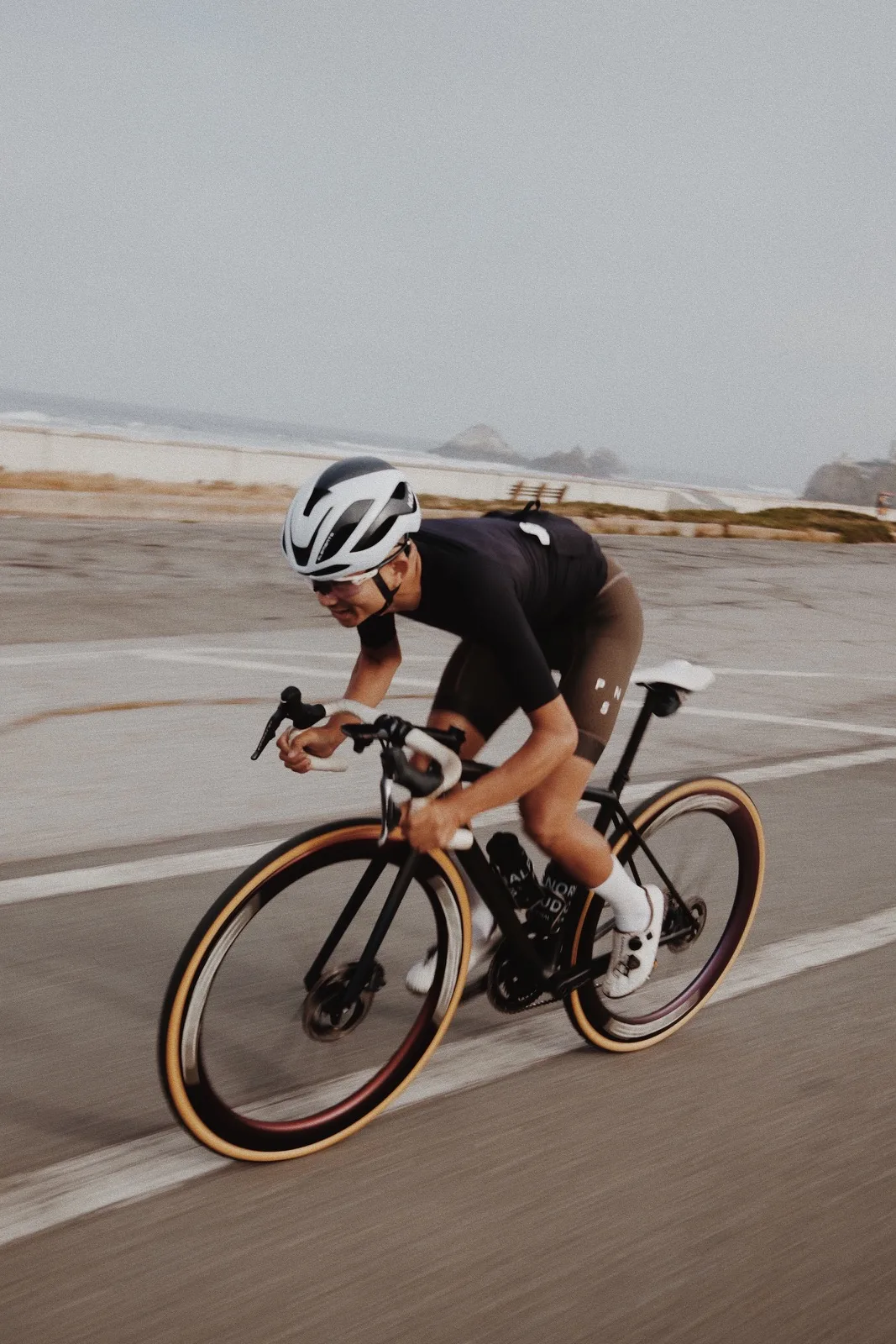 A cyclist tucked low over the handlebars