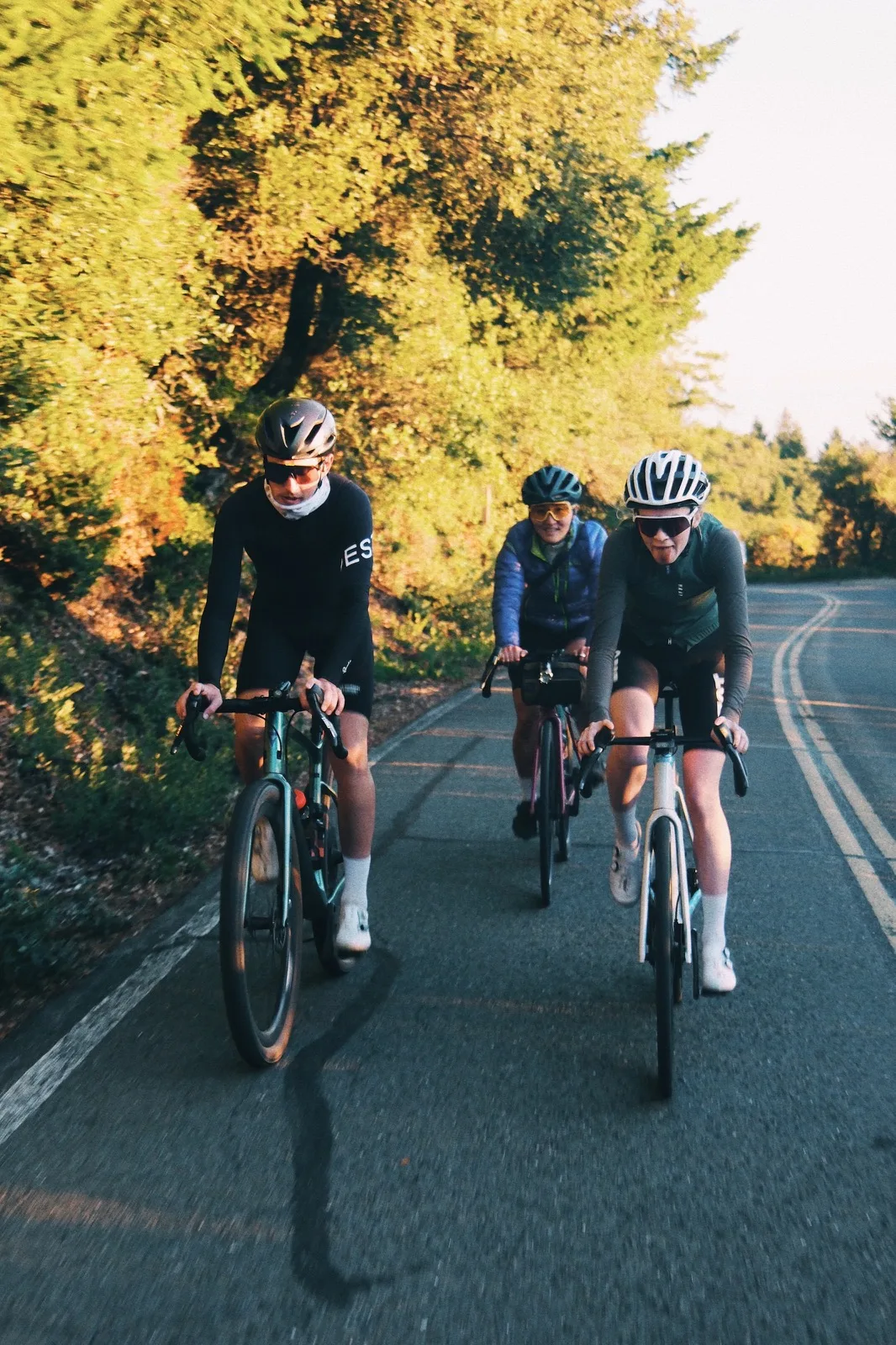 A group ride passing beneath autumn foliage