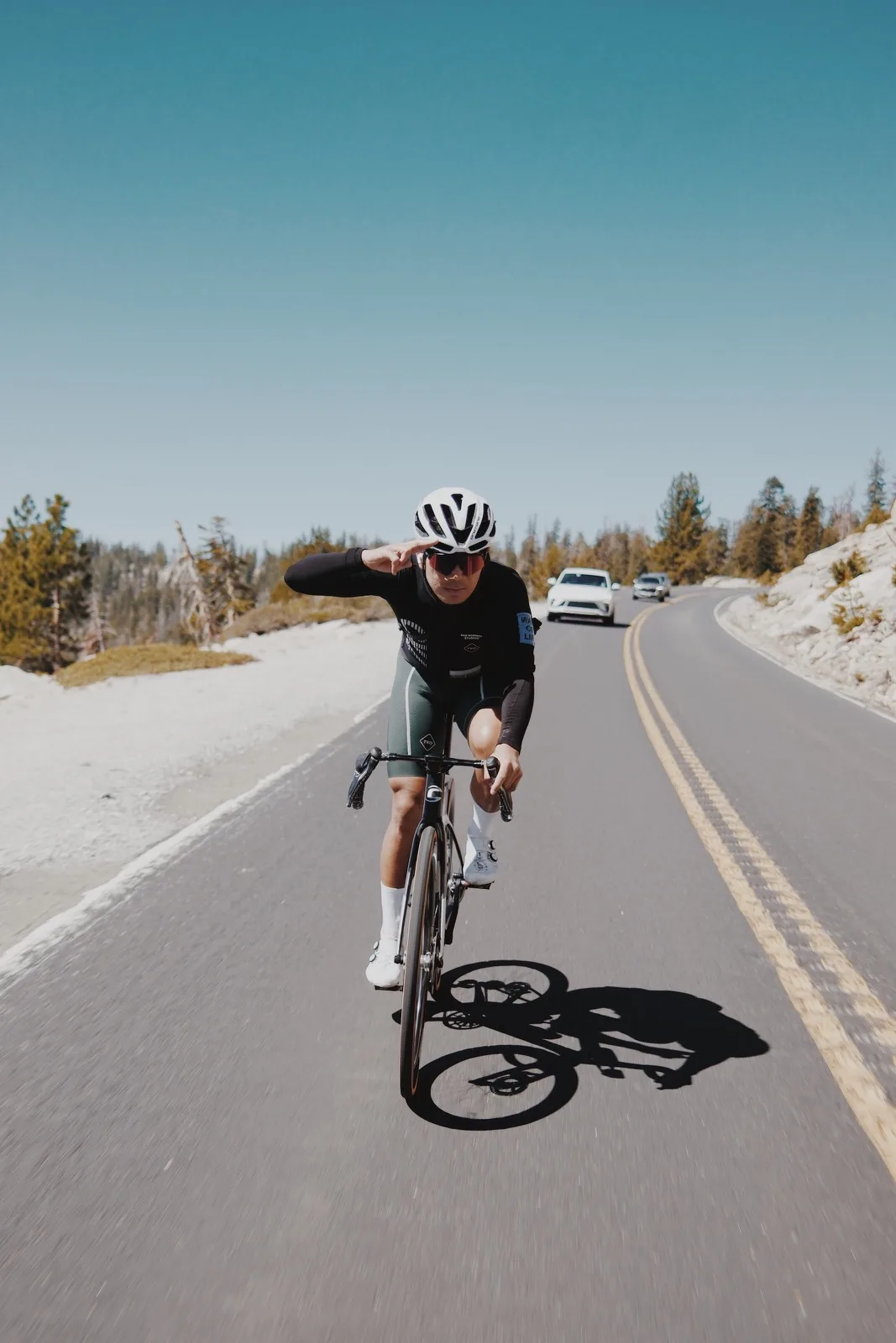 A cyclist riding alone on a snowy road