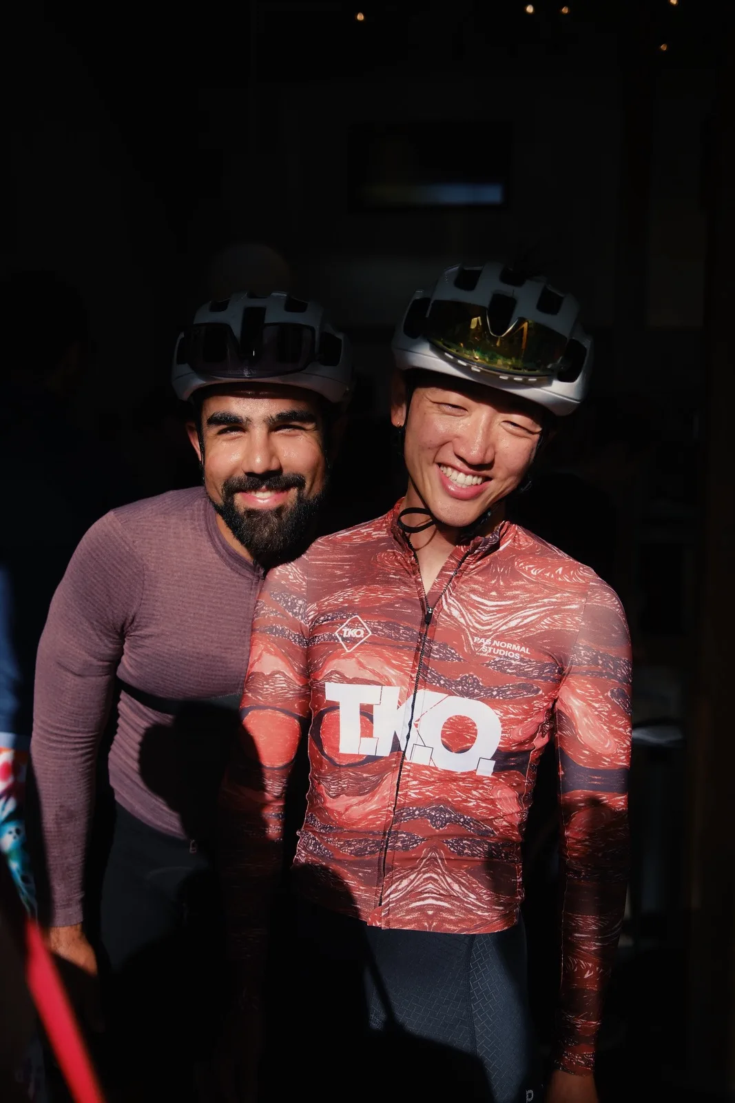 Two cyclists pausing together for a roadside portrait