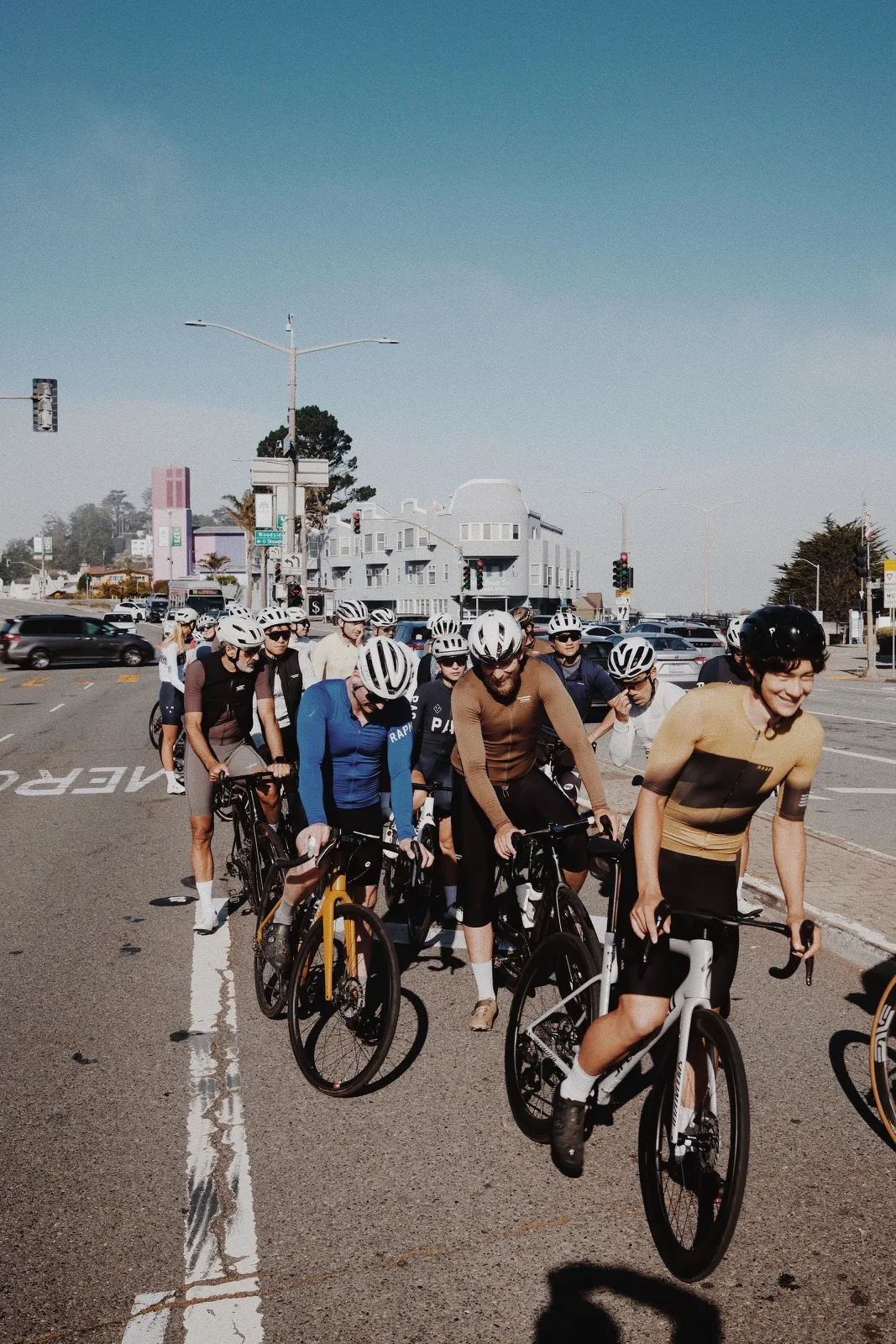 A large group of cyclists rolling together through San Francisco