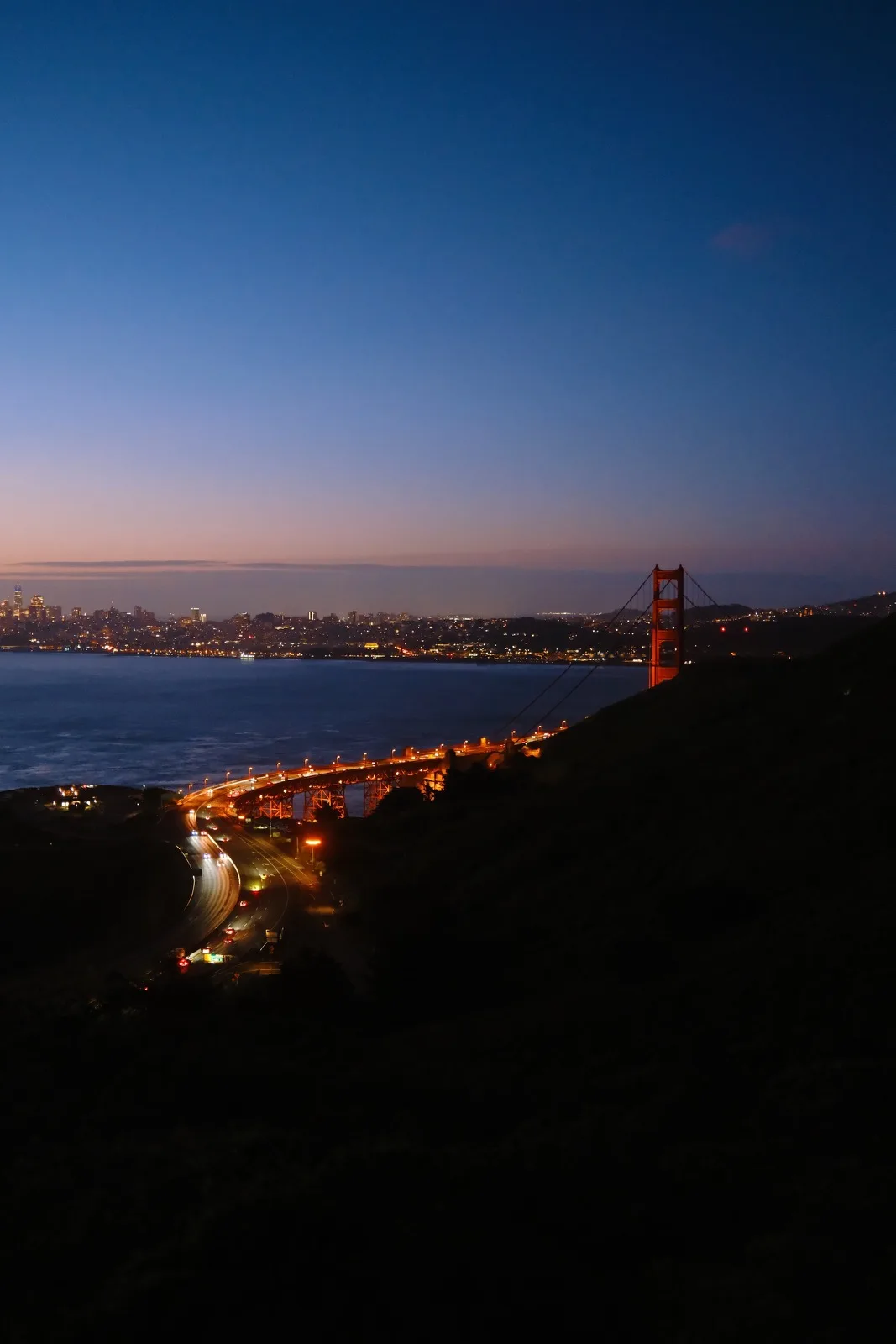 The Golden Gate Bridge and city lights after dark
