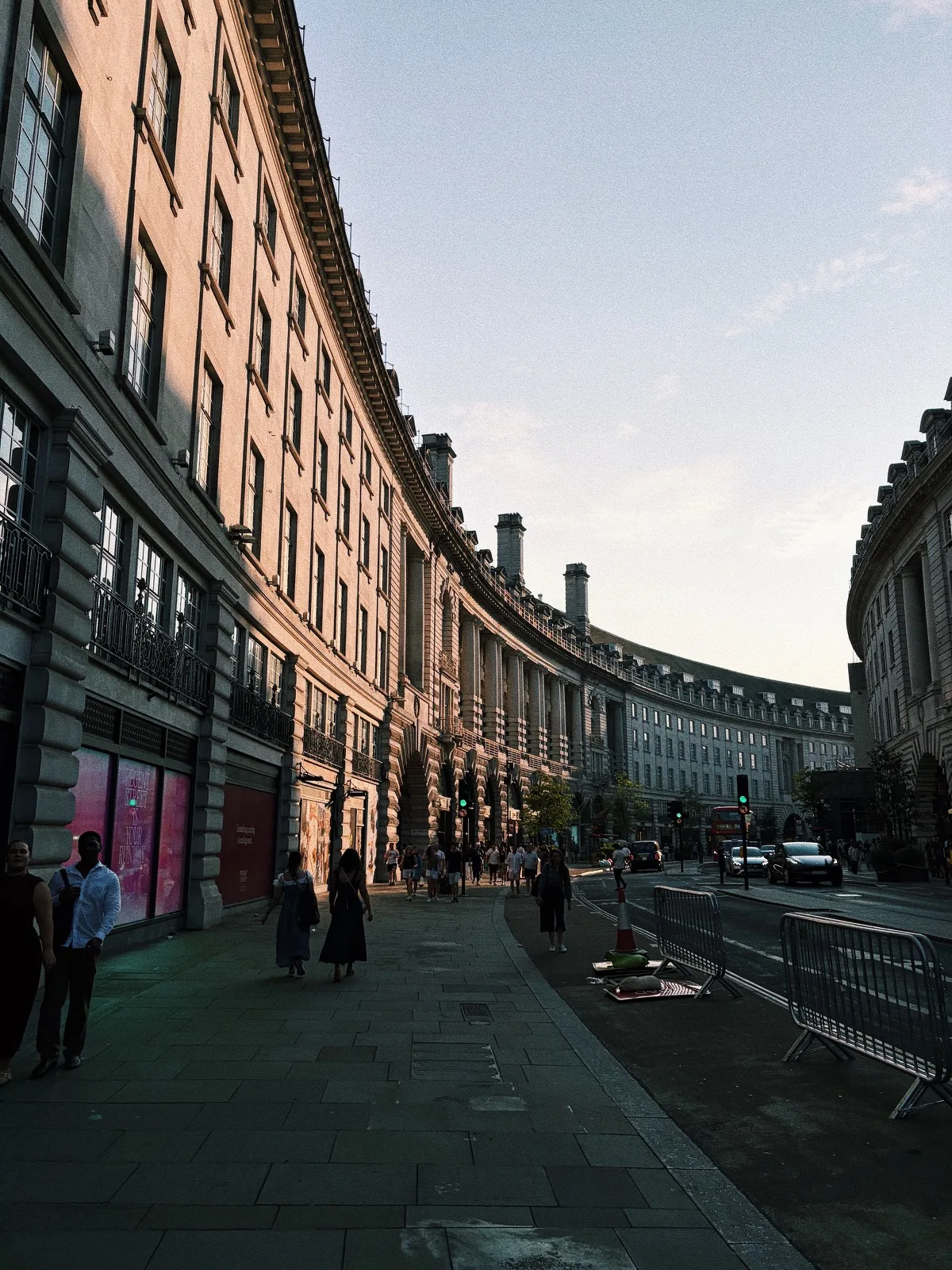 A curved London street catching the last warm light