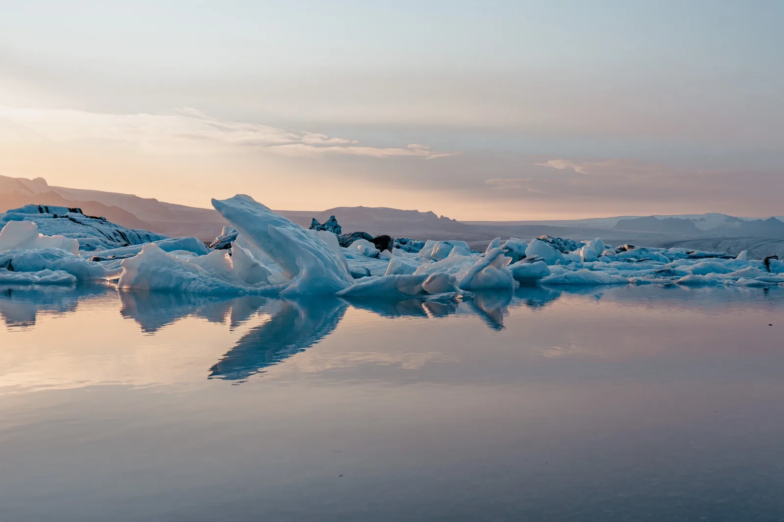 Blue icebergs floating in a still glacial lagoon