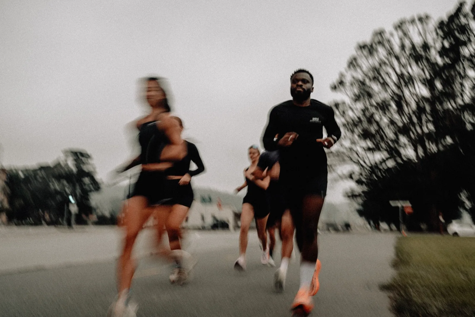 MRC runners approaching the camera on a coastal road