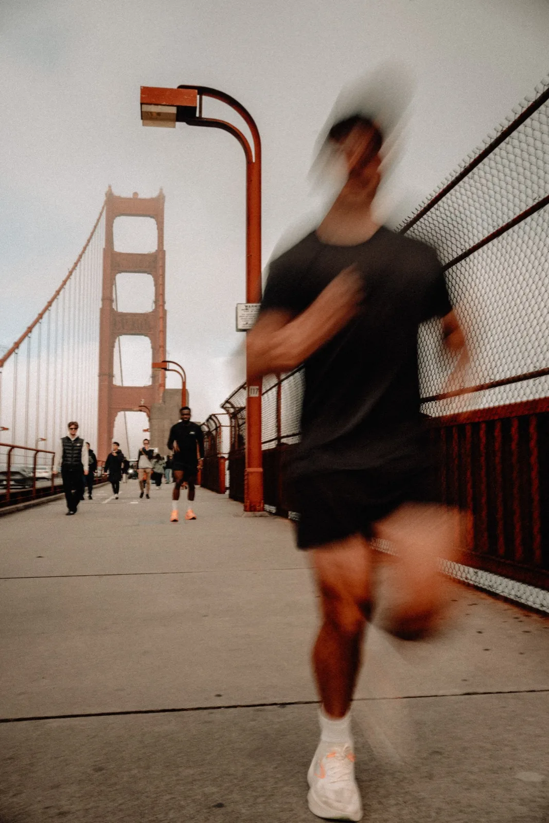 A running group framed by the Golden Gate Bridge