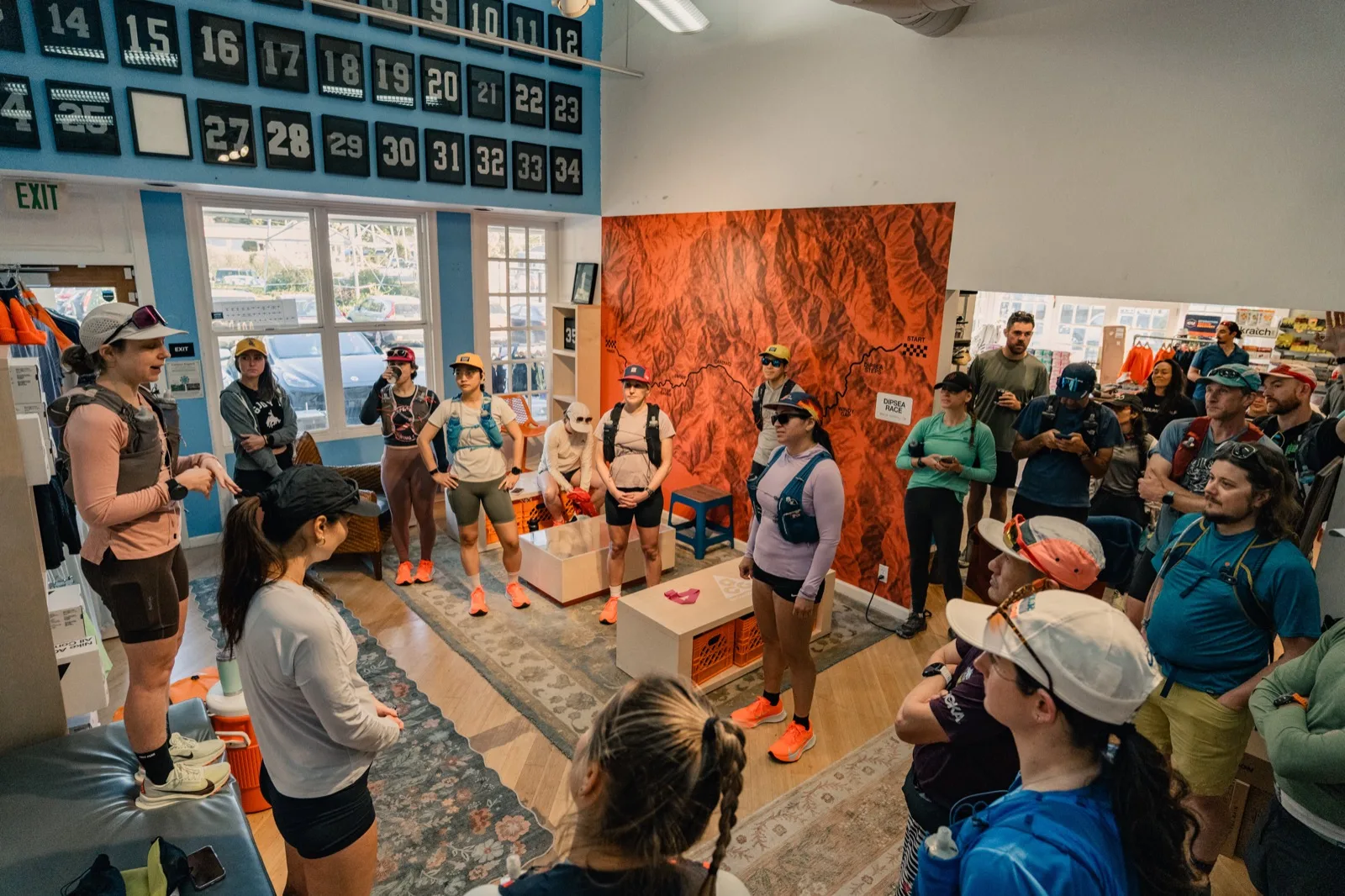 A crowded trail briefing inside a running shop