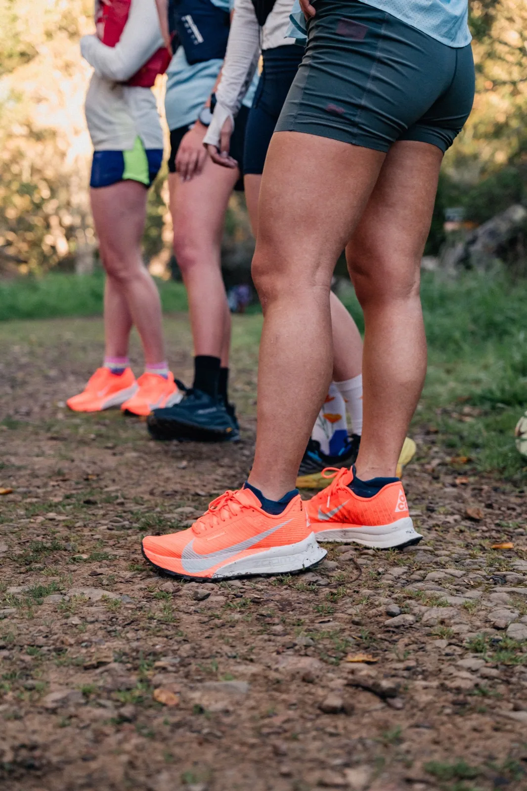 Orange trail shoes moving over dirt