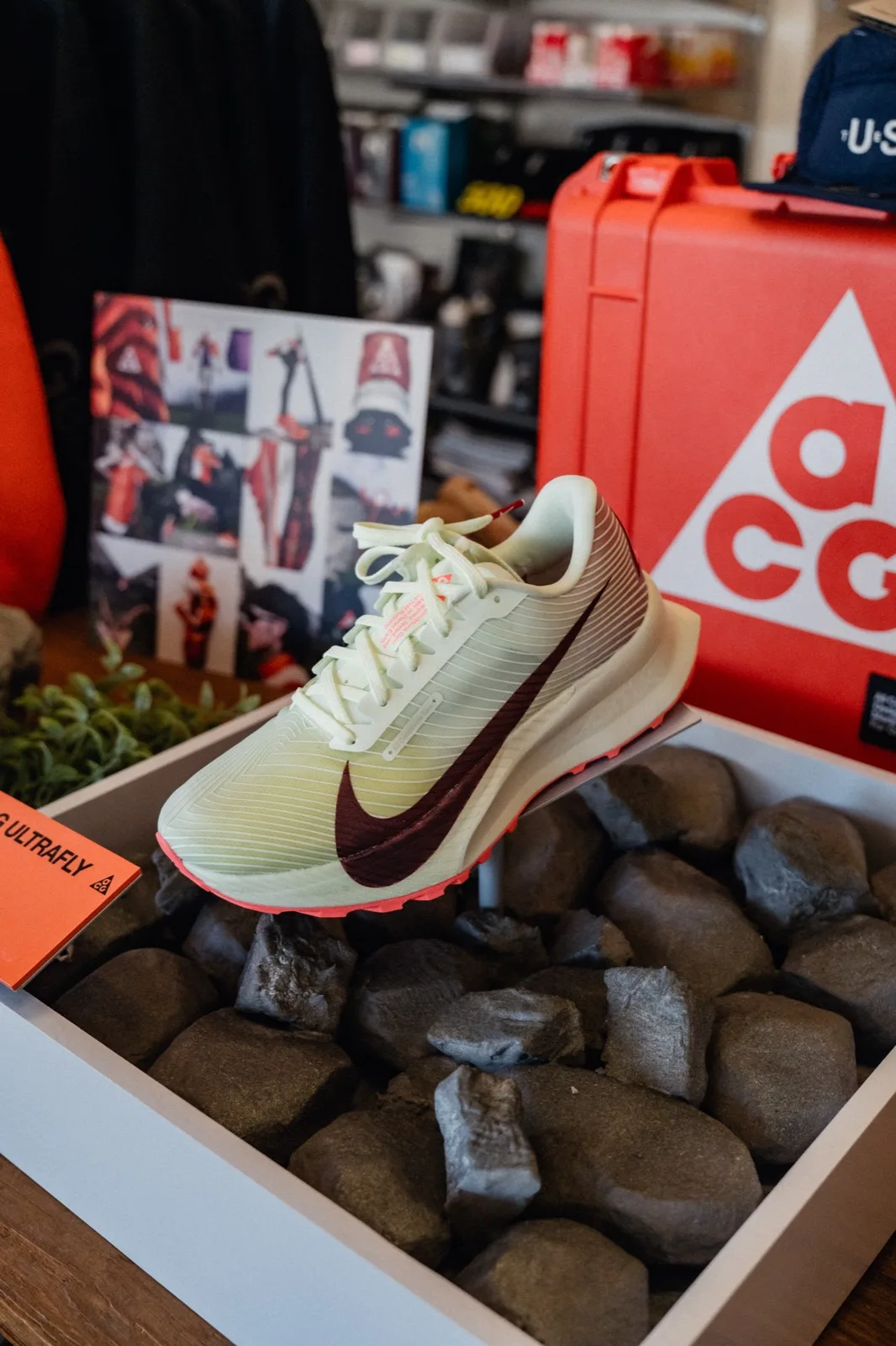 A Nike ACG trail shoe displayed on stones