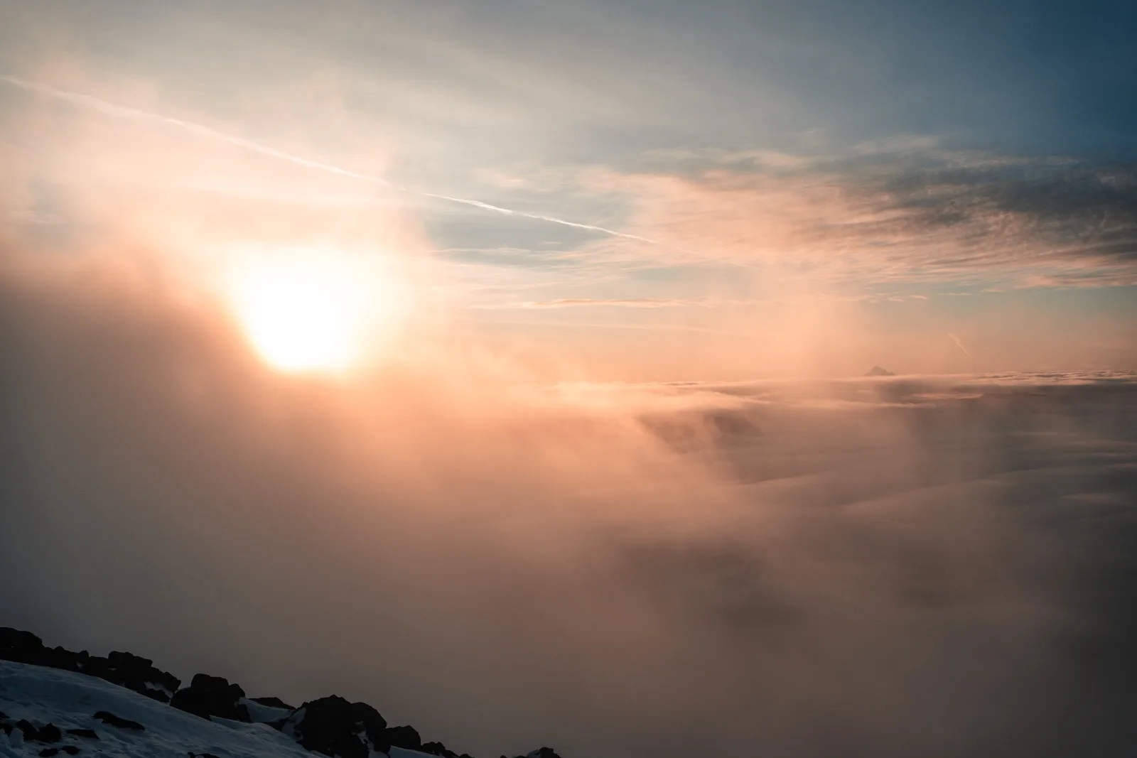 Alpine clouds glowing coral before sunrise