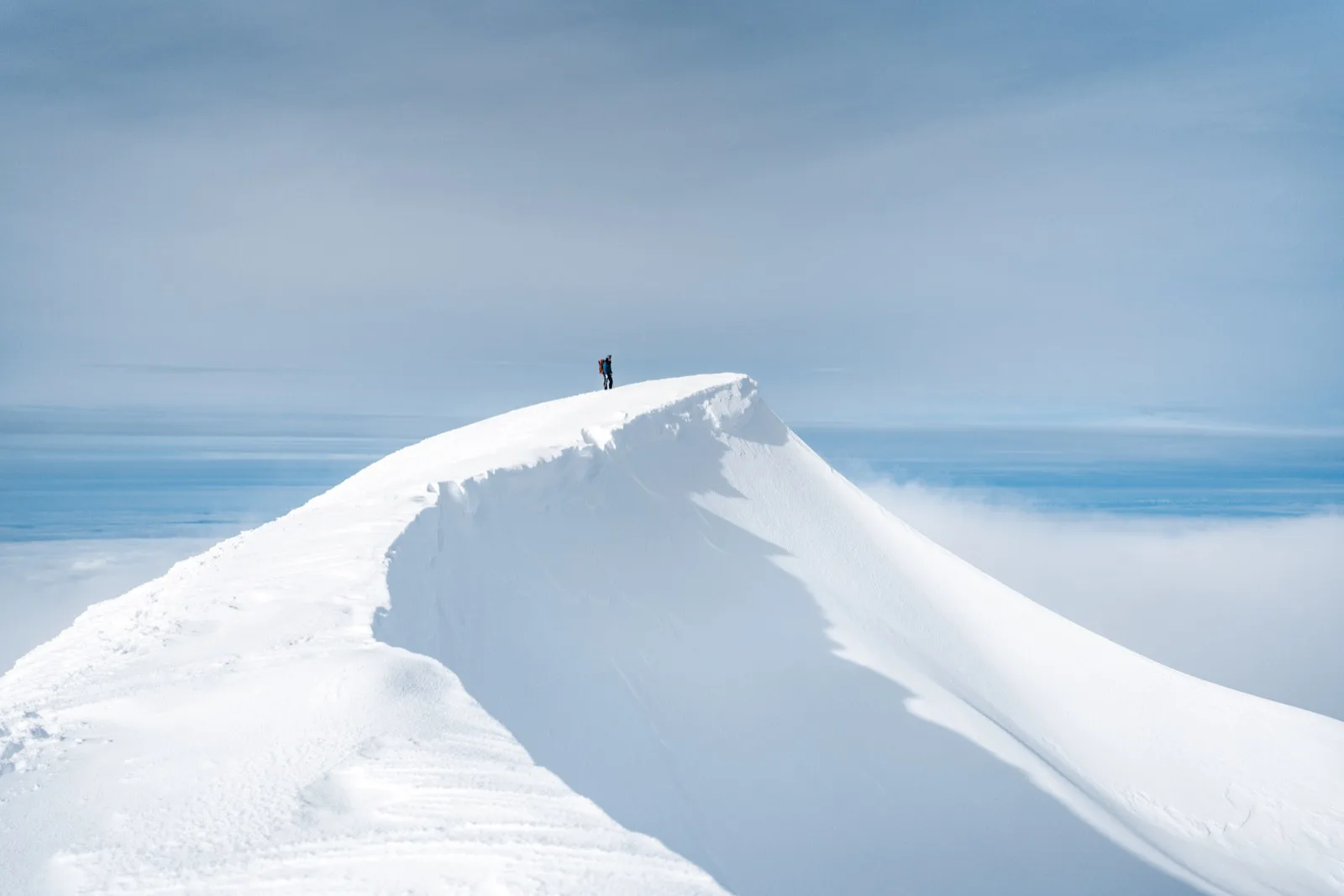 A wind-carved cornice rising against a pale sky
